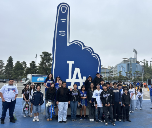 The group of students standing in front of a LA foam finger.
